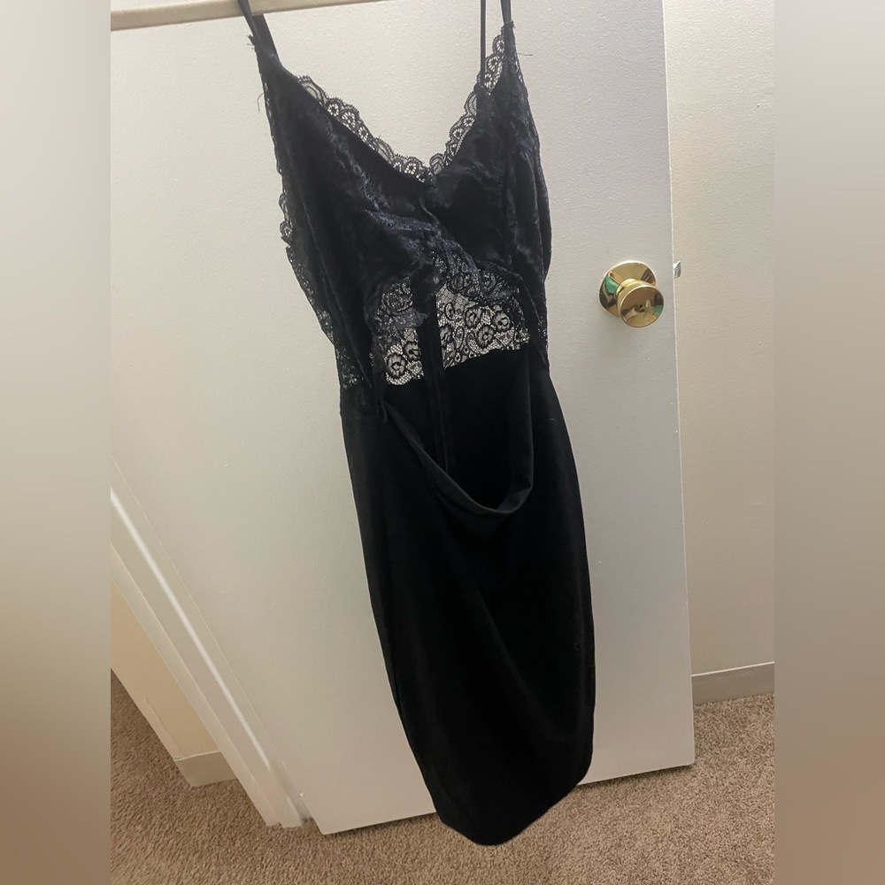 Black mid-length cocktail dress. Size L. Never worn. Stretchy material. Mesh top
